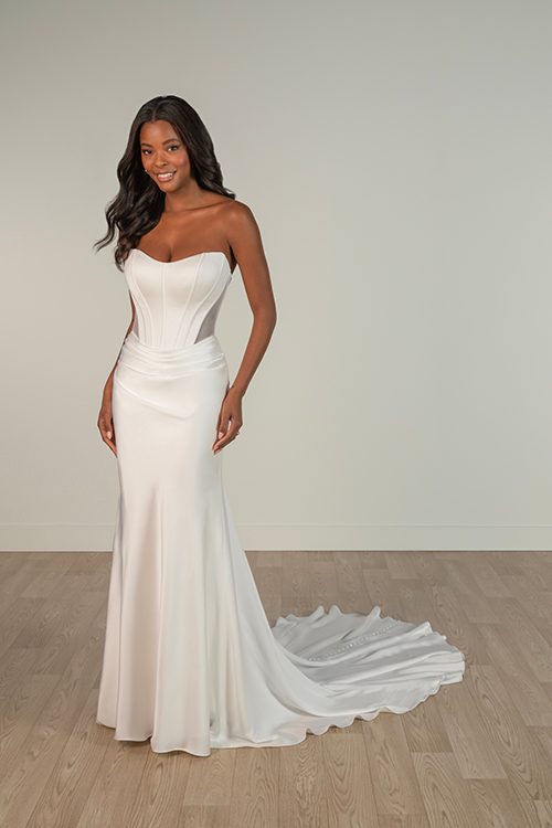 Model is wearing a strapless corset sheath wedding dress