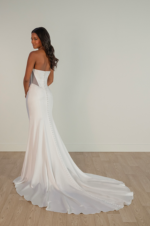 Model is wearing a strapless corset sheath wedding dress