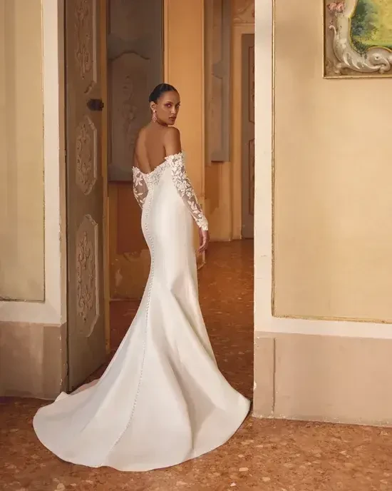 Model is wearing a mikado fit and flare bridal gown 