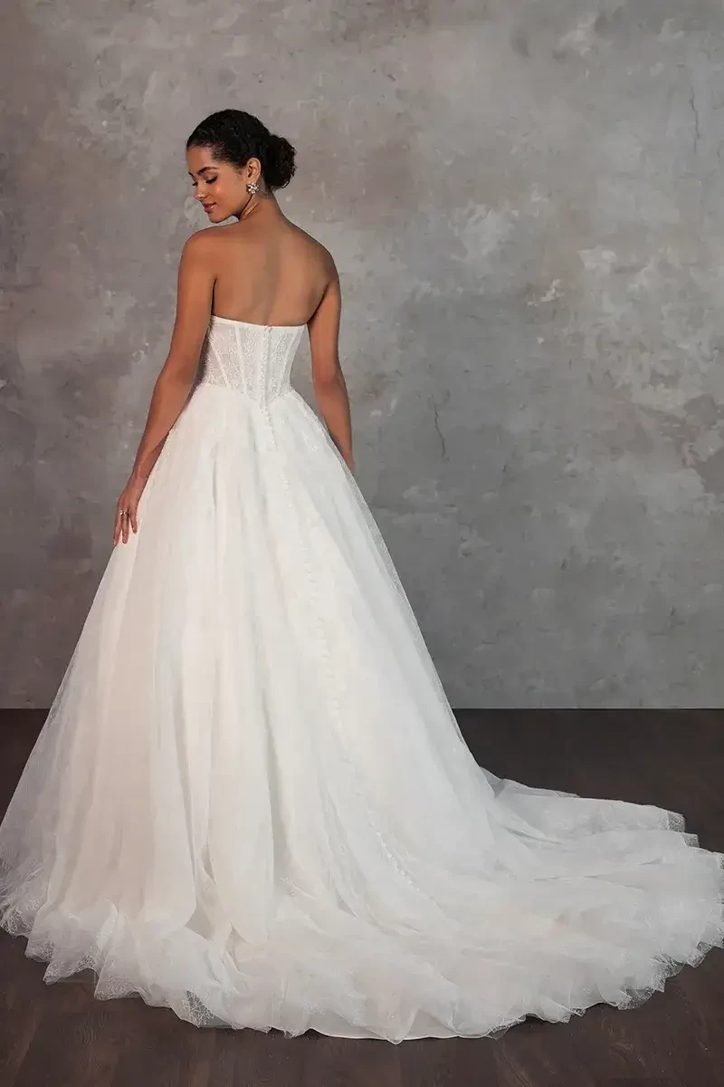 model is wearing a strapless a-line wedding gown