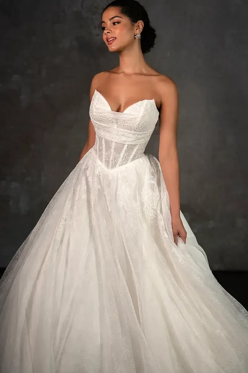 model is wearing a strapless a-line wedding gown