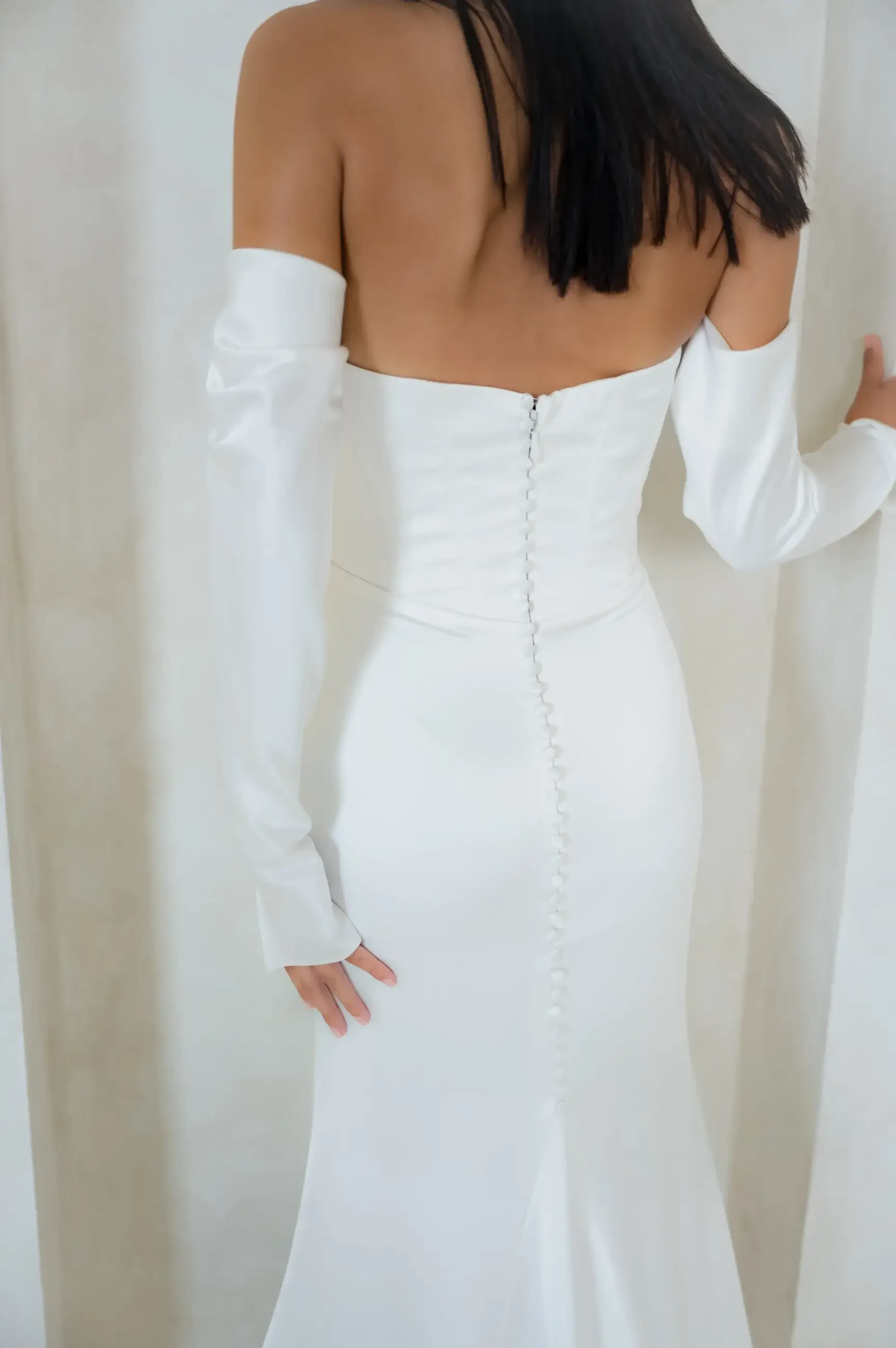 Model is wearing a strapless fitted scoop neckline wedding dress 