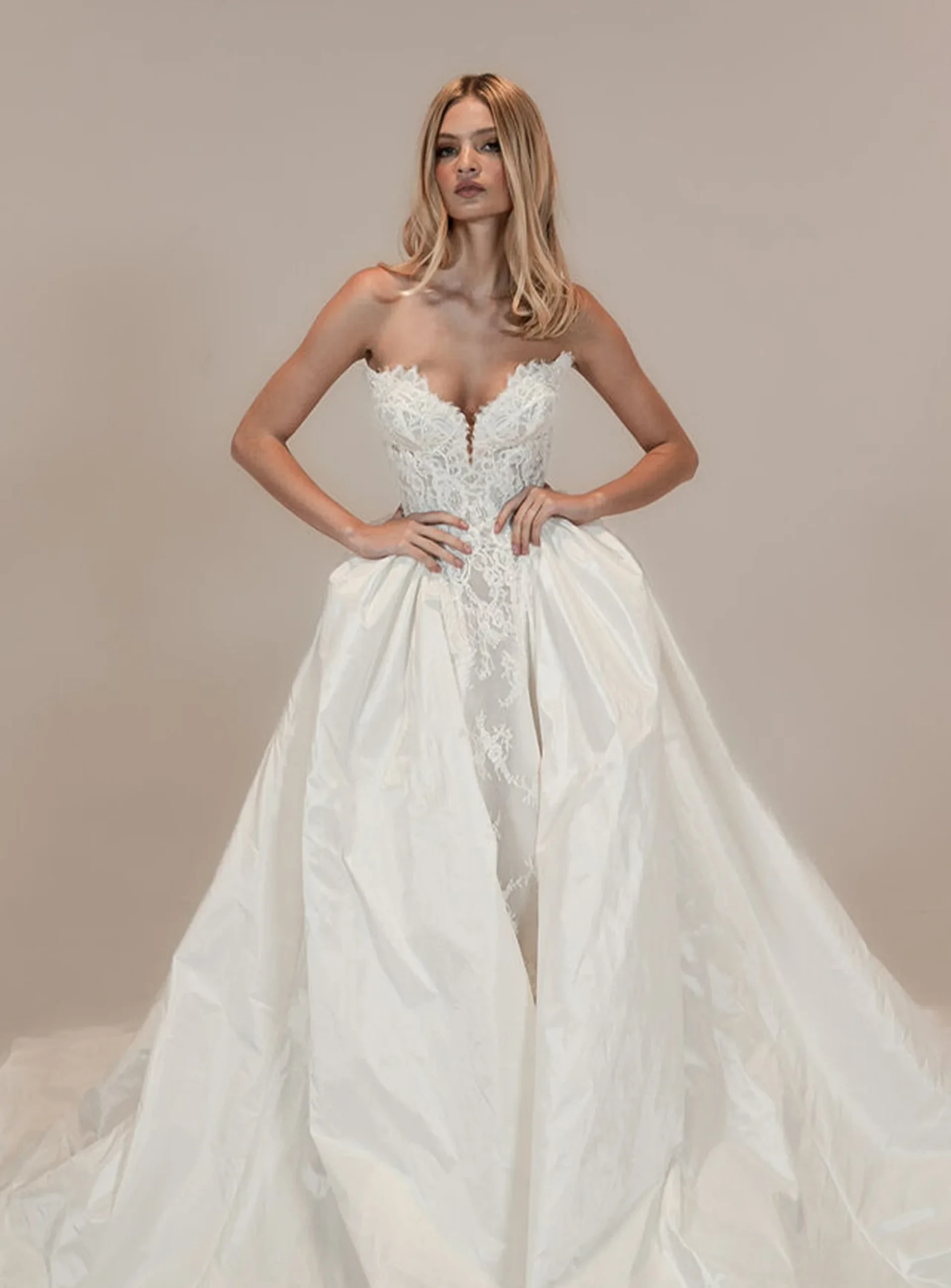 Colby John strapless lace wedding gown with dramatic detachable overskirt.