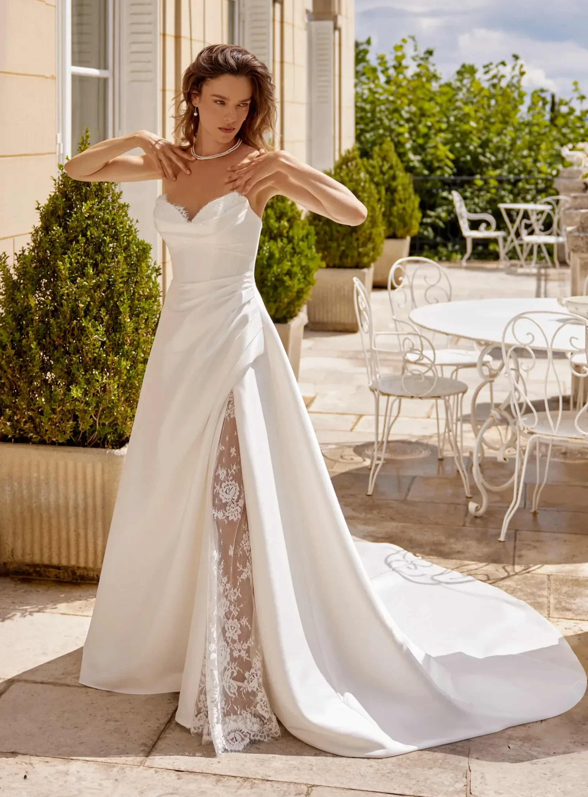 Justin Alexander satin wedding gown with lace-lined slit and sweeping train.