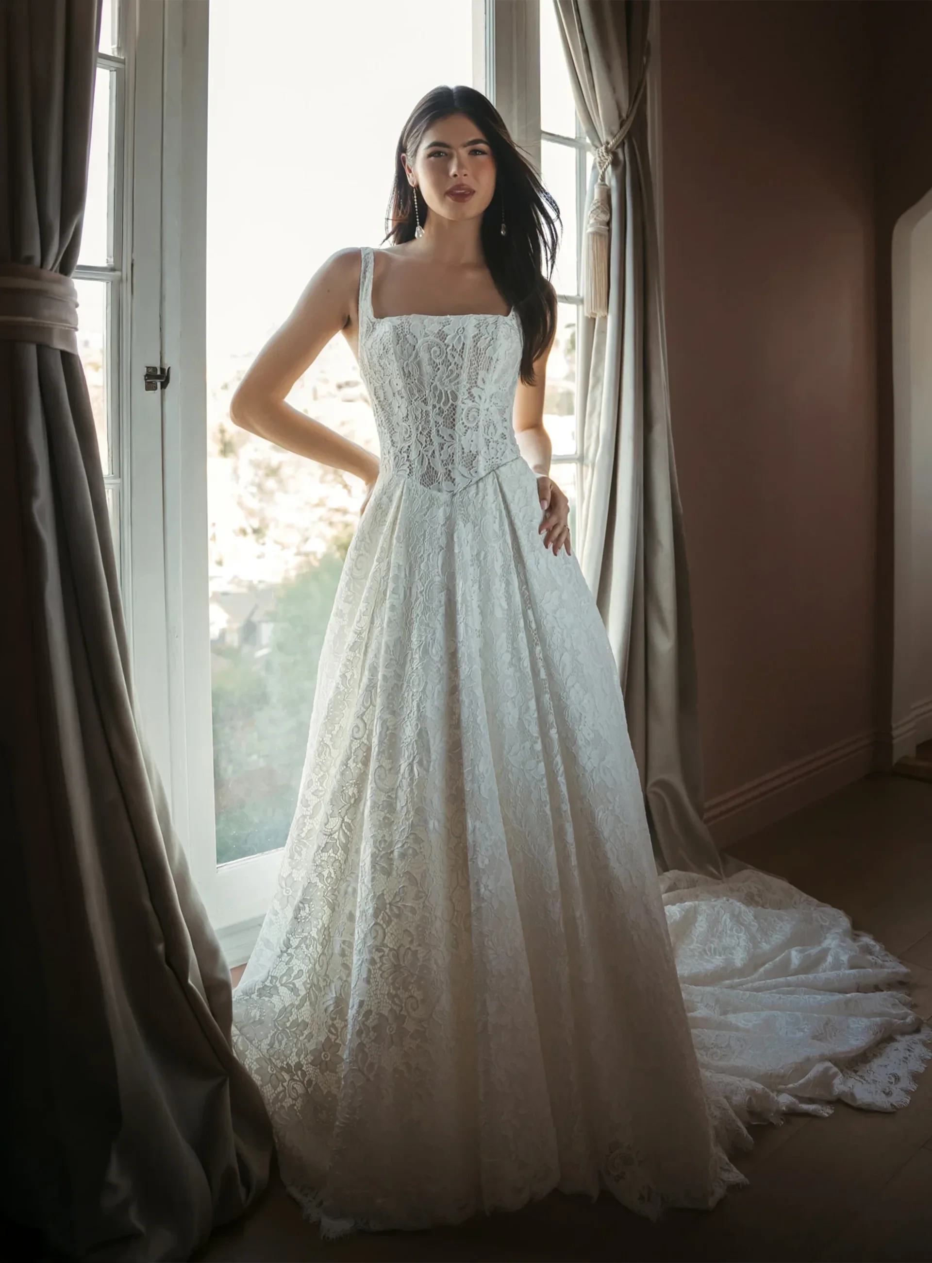 Stella York lace A-line wedding gown with square neckline and structured bodice.