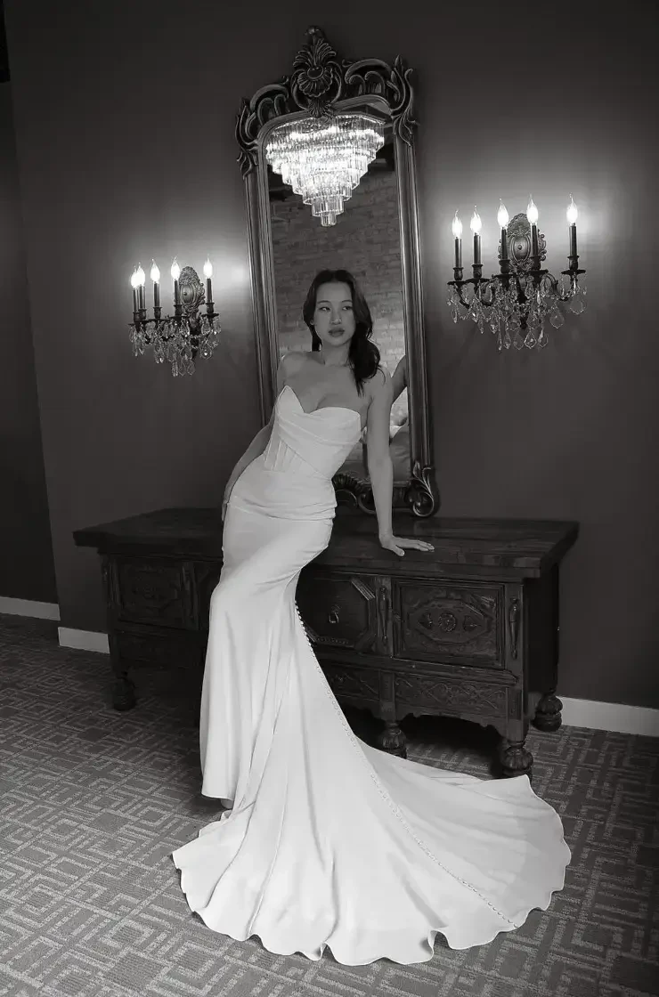 model is wearing a strapless fit and flare wedding dress