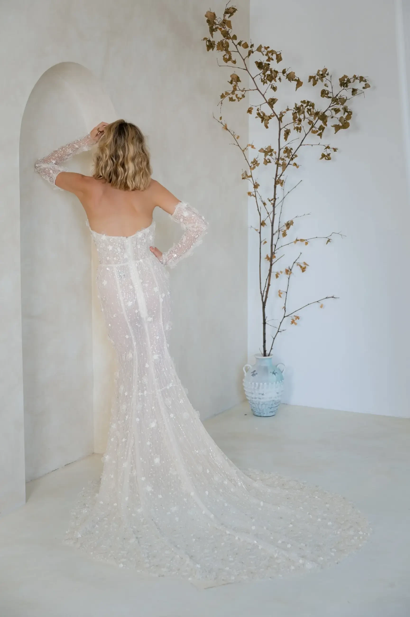 model is wearing a strapless beaded bridal gown