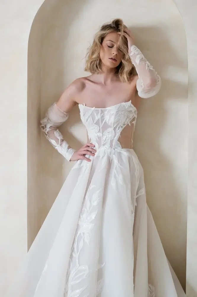 model is wearing an off the shoulder a-line bridal gown